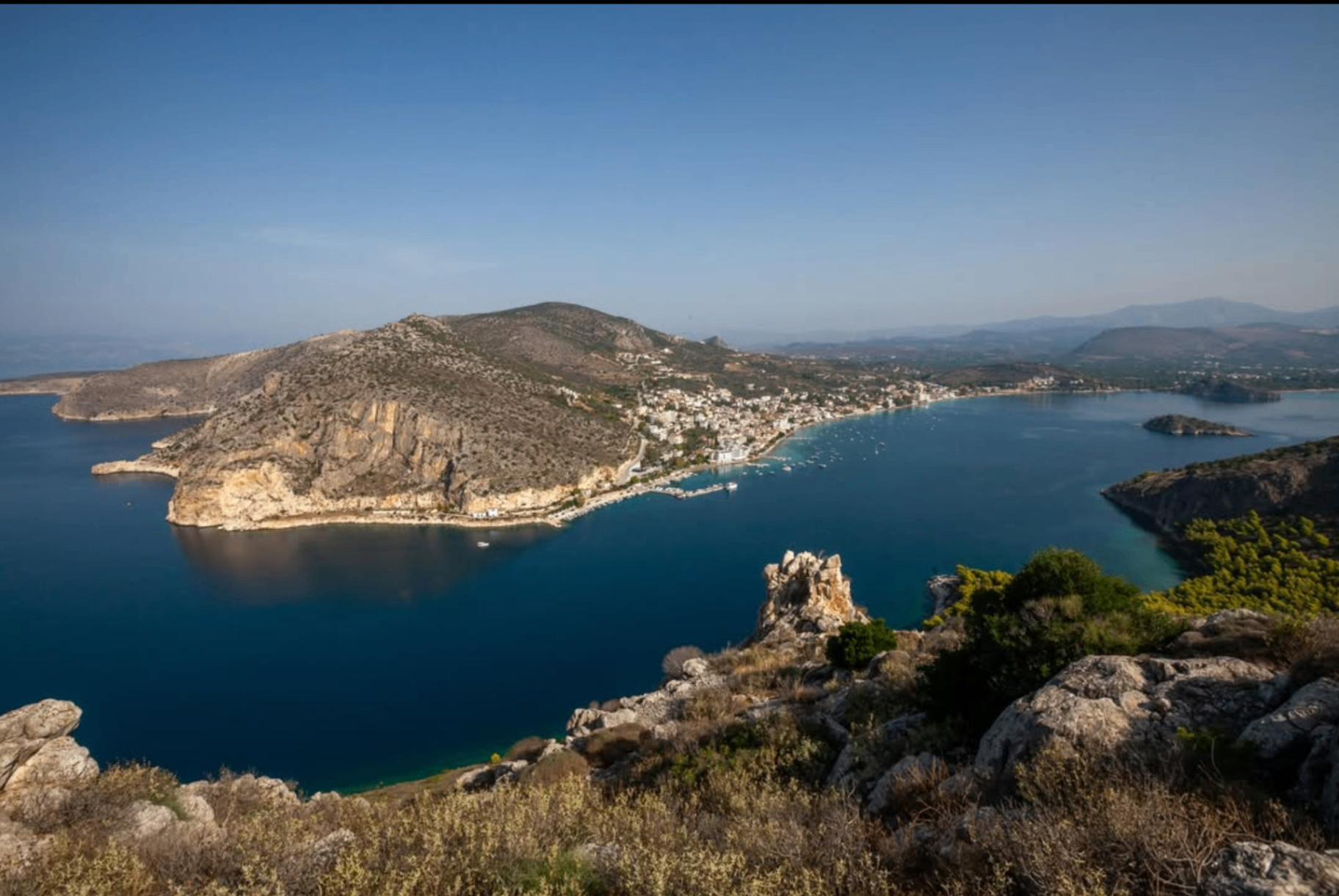 Panoramic clifftop view over Tolo Bay