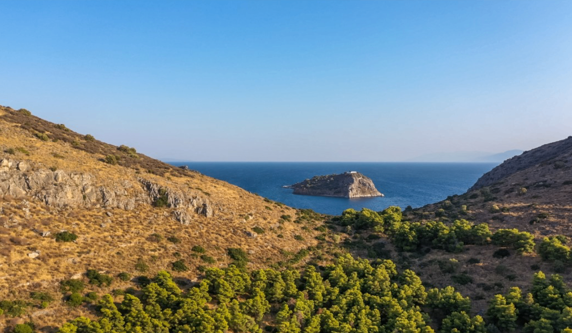 Hillside view toward the islet and coastline of Tolo